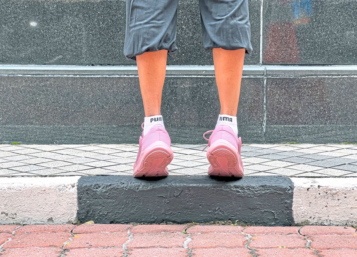 Keeping your knees straight, slowly lift both heels up as high as you can.