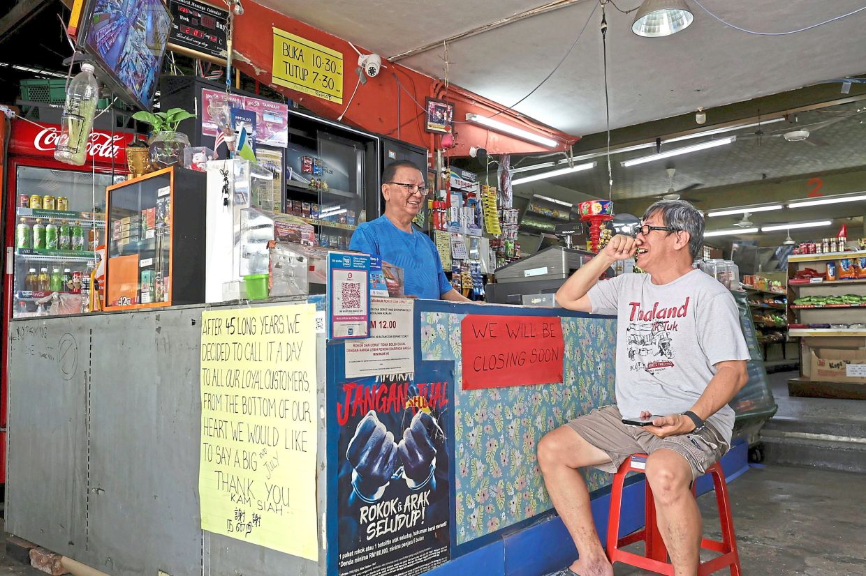Teik Hoon (left) and his brother Keh Hoon, 56, having a light moment at the shop in Jalan Tan Sri Teh Ewe Lim, Penang.