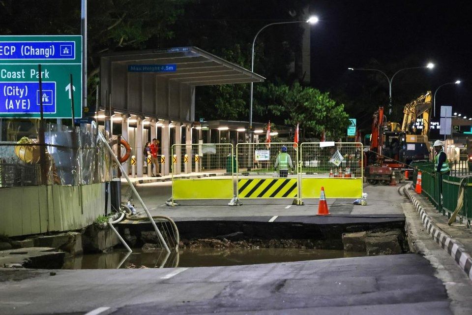 The sinkhole had been filled with water, but it was dry when workers rescued the driver. - Photo: ST