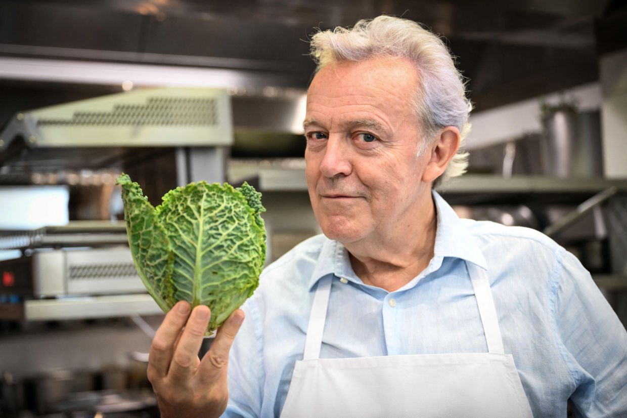 French chef Alain Passard poses in his restaurant 'L'Arpege' in Paris during a photo session. – Photo by BERTRAND GUAY/ AFP)
