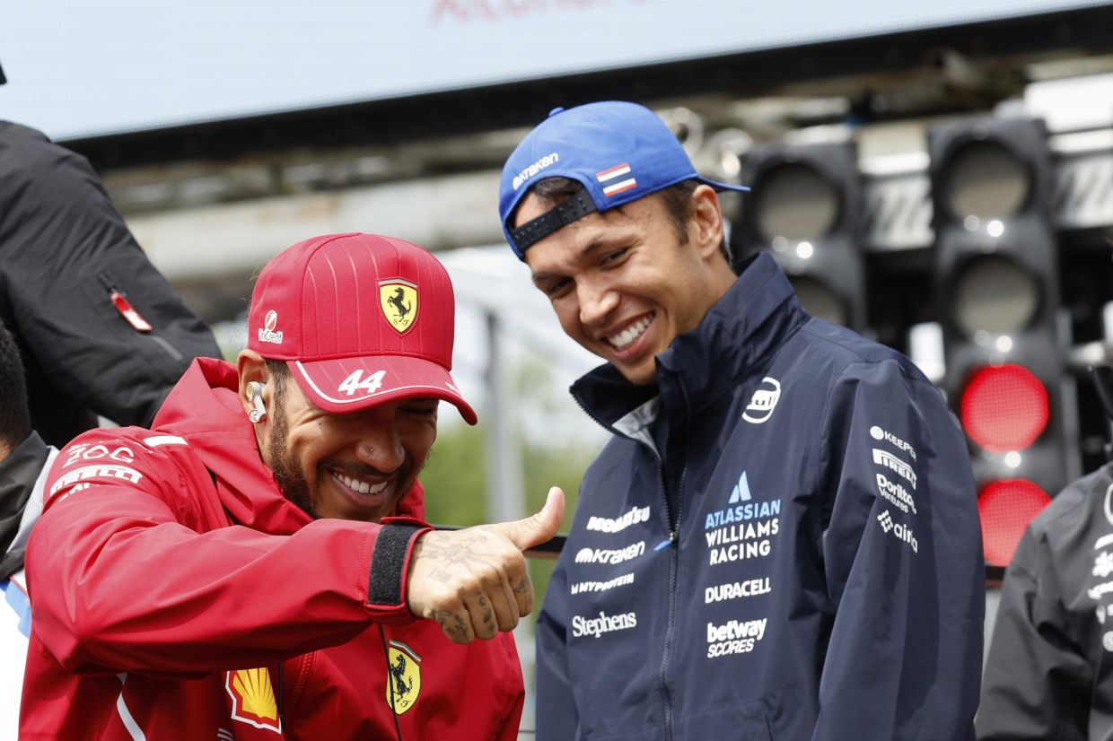 Ferrari driver Lewis Hamilton of Britain, left, and Williams driver Alexander Albon of Thailand during the drivers parade prior to the Formula One Grand Prix at the Spa-Francorchamps racetrack in Spa, Belgium, Sunday, July 27, 2025. -- AP Photo/Geert Vanden Wijngaert