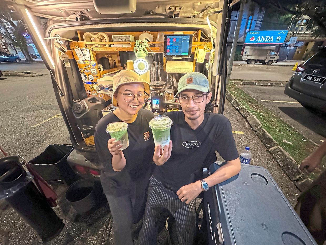 Hanim (left) and Safwan at their pop-up coffee stall in Taman Melawati.