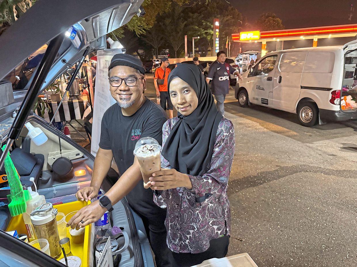 Far left: Shahril, with wife Effa Ereny Baharudin, 45, selling coffee from the trunk of their car in Taman Melawati.