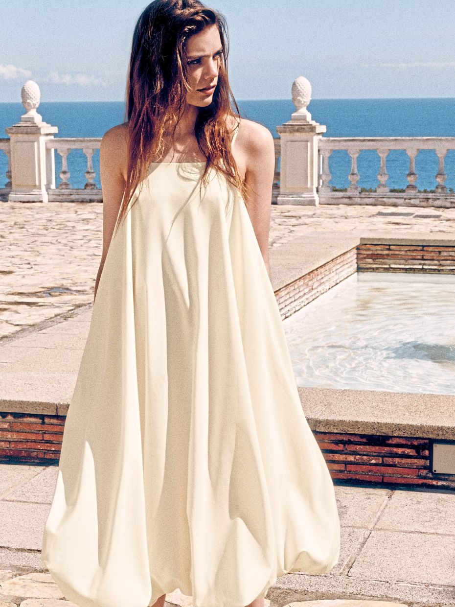 This Bubble-Hem midi dress is rendered in a soft, buttery tone. Photo: Cos