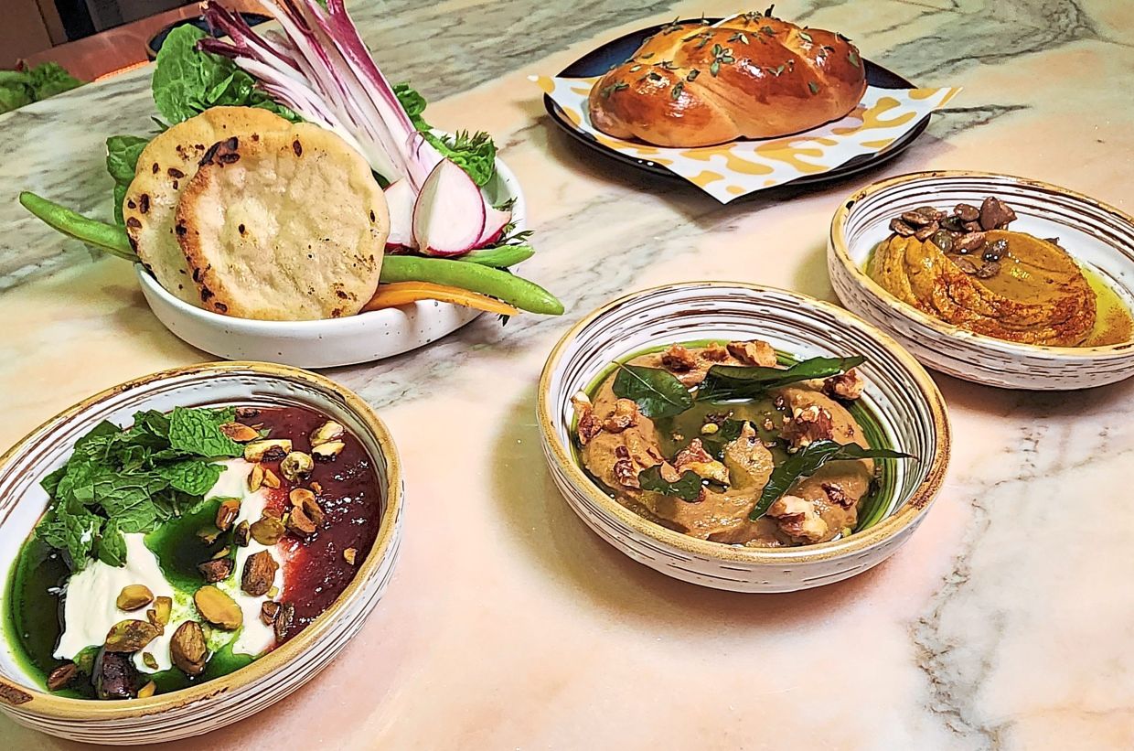 The restaurant's range of dips (from left: labneh, baba ganoush and pumpkin hummus) are very, very good. — ABIRAMI DURAI/The Star