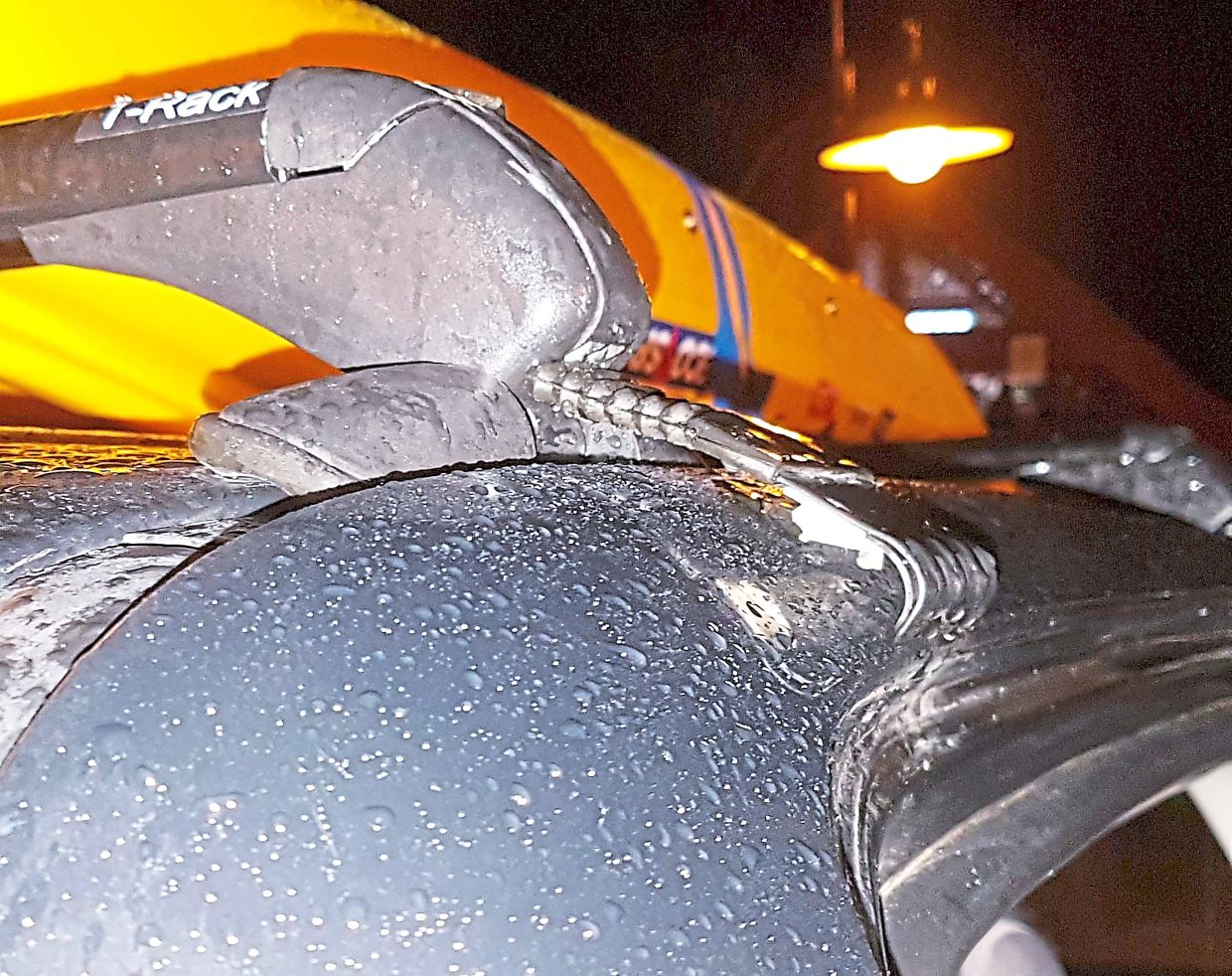 PLAAK! The grip of a cheap roof rack popping free after the car hit a pothole at high speed.