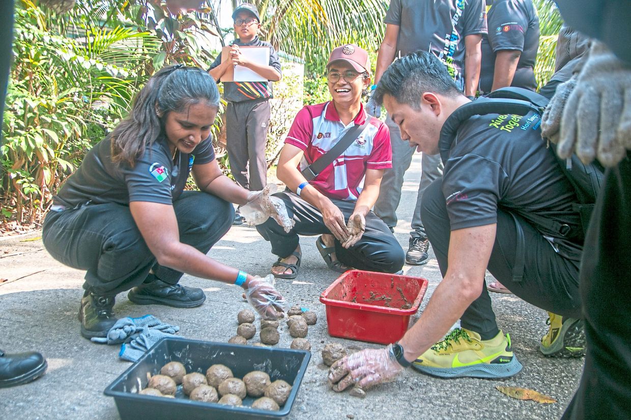One of the activities at the event is making mud balls.