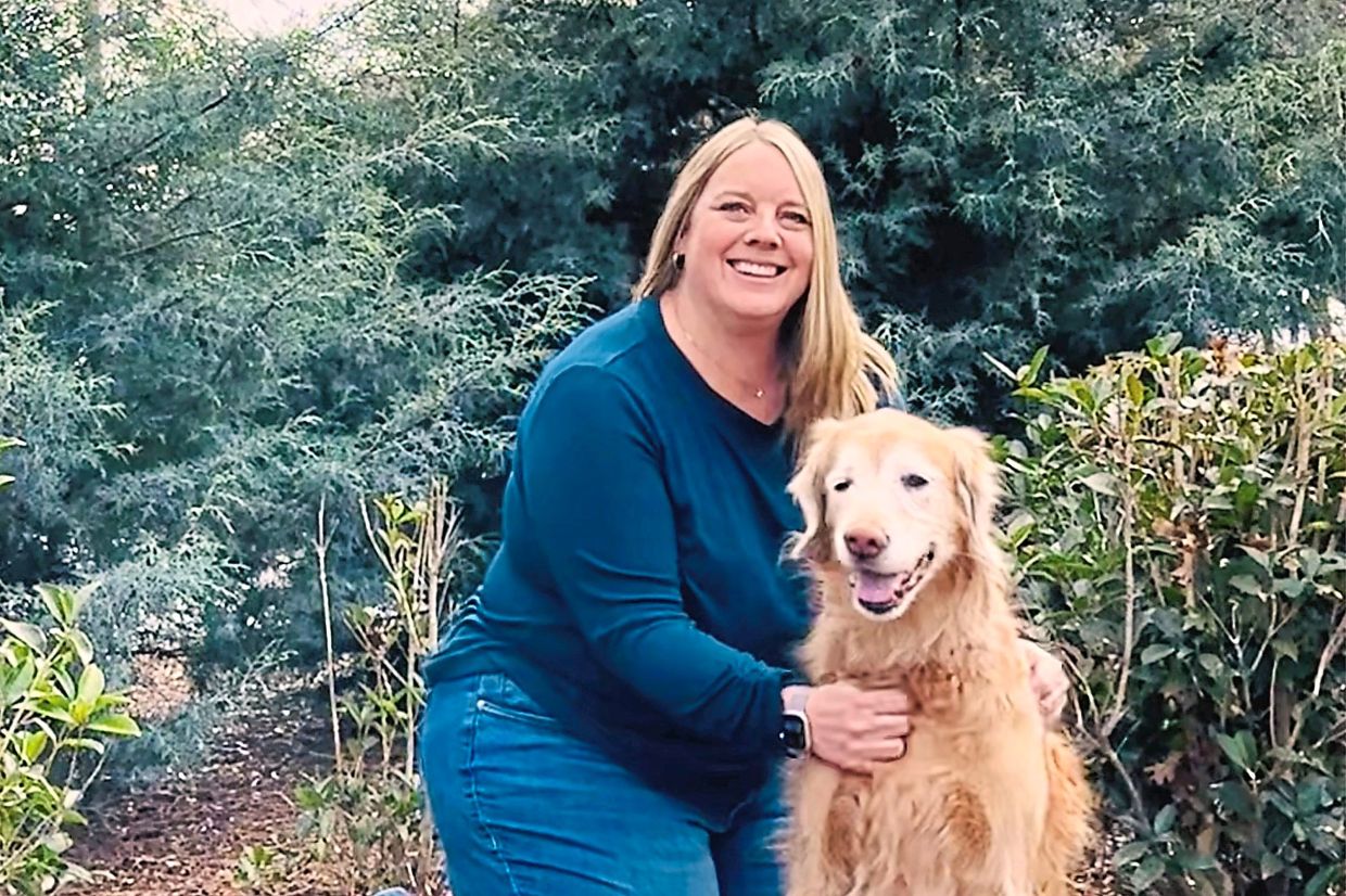 Wilson poses with her dog Sadie. — KRISTINA DEFRAIN/AP