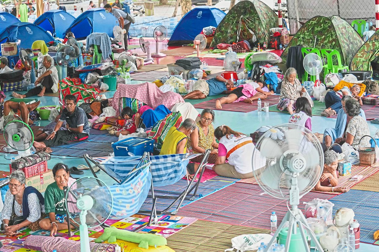 Waiting to leave: Thai residents resting at an evacuation centre in Surin province, Thailand. — AP
