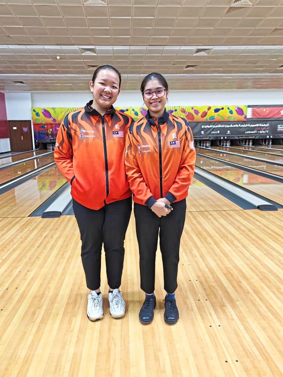 All smiles: Qurratu’Ain Izdihar Pozi (left) and Adelia Nur Irwan Syazalee posing for a photograph after their Asian Junior Championships girls’ doubles event.