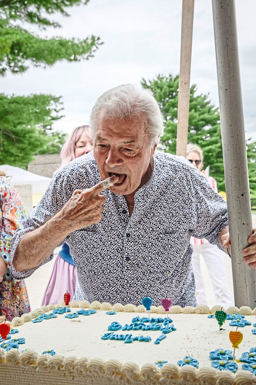 Jacques Pépin eats cake during one of his 90 birthday parties to celebrate his 90th birthday, at Yellowframe Farm in Millbrook, N.Y., July 19, 2025. The beloved chef, who brought French cooking skills to the American masses, is celebrating his upcoming birthday with 90 parties around the country. (Lauren Lancaster/The New York Times)