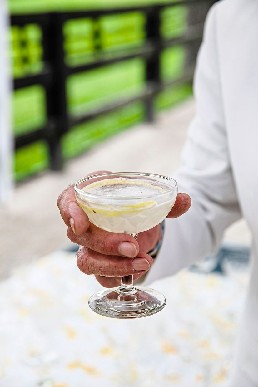 A guest with a French 75 cocktail — renamed the “Jacques 90” for the night — during one of Jacques Pépin’s 90 birthday parties.