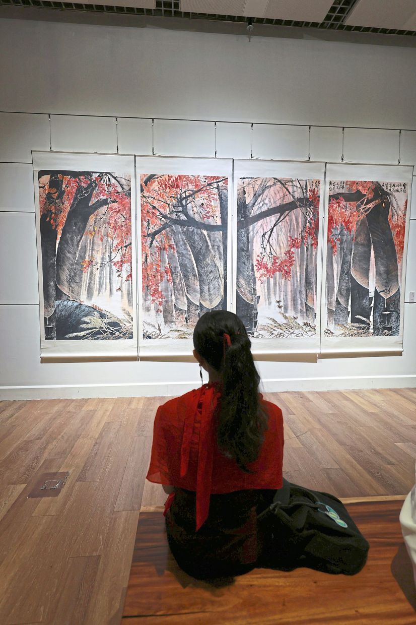 An art lover admiring Hon’s collection from his ‘Rubber Tree’ series at the exhibition titled ‘Depicting the Beauty of Nature’ at Wisma Sokka Gakai. — Photos: KAMARUL ARIFFIN/The Star