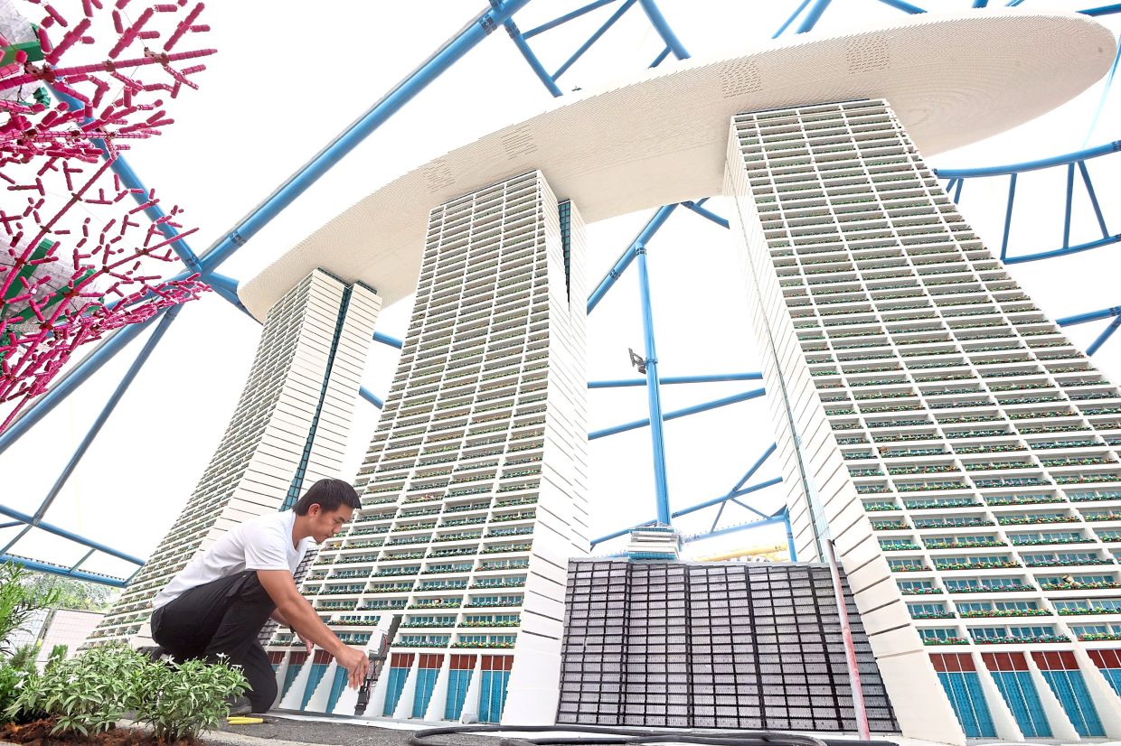 A technician putting finishing touches to a Marina Bay Sands replica.