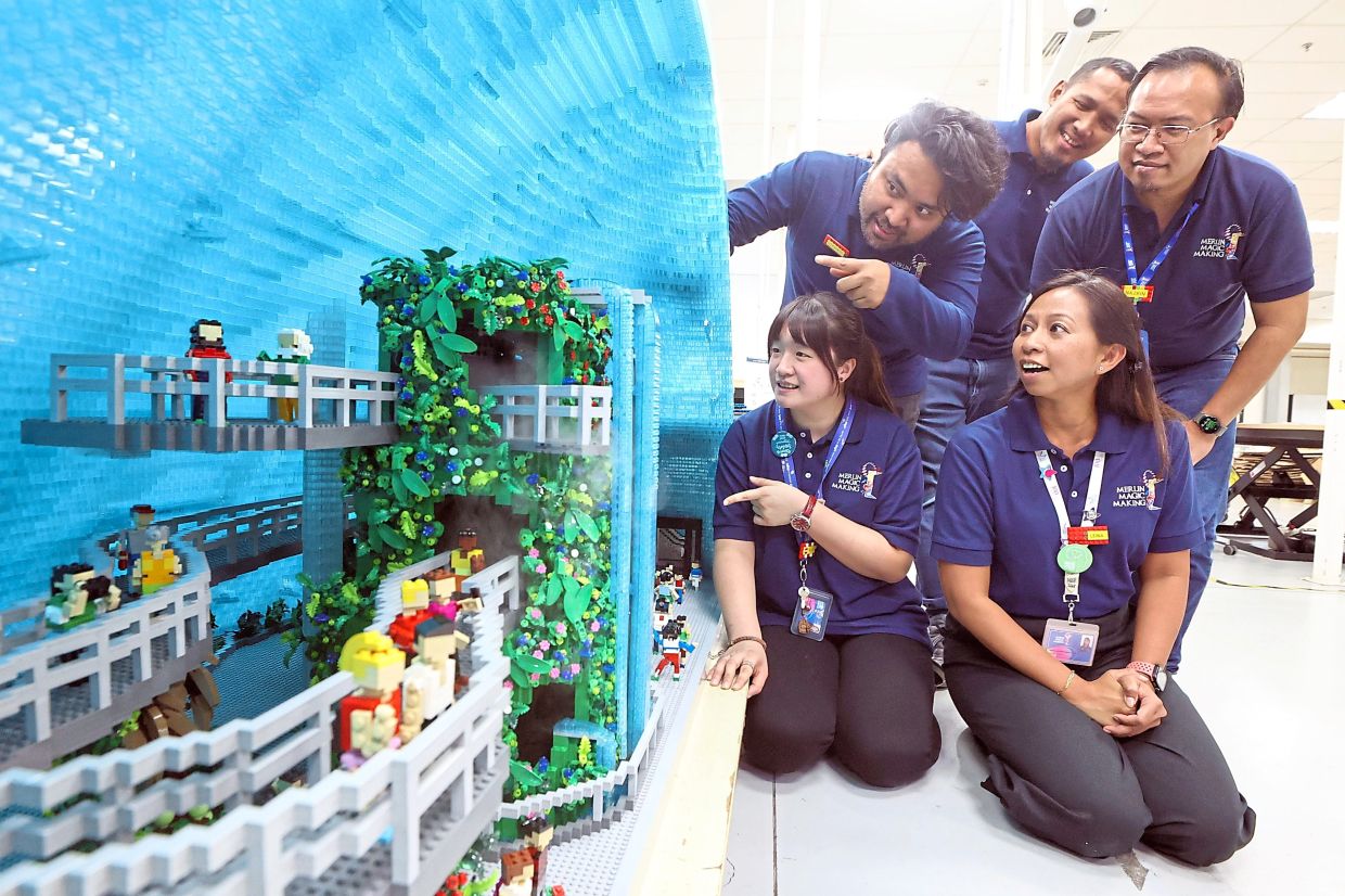 (Clockwise from front right) Leina, Chai, Muhammad Fais, Syed Mohd Izzudin and Muhammad Nazrin at the production hub with a completed Cloud Forest replica.