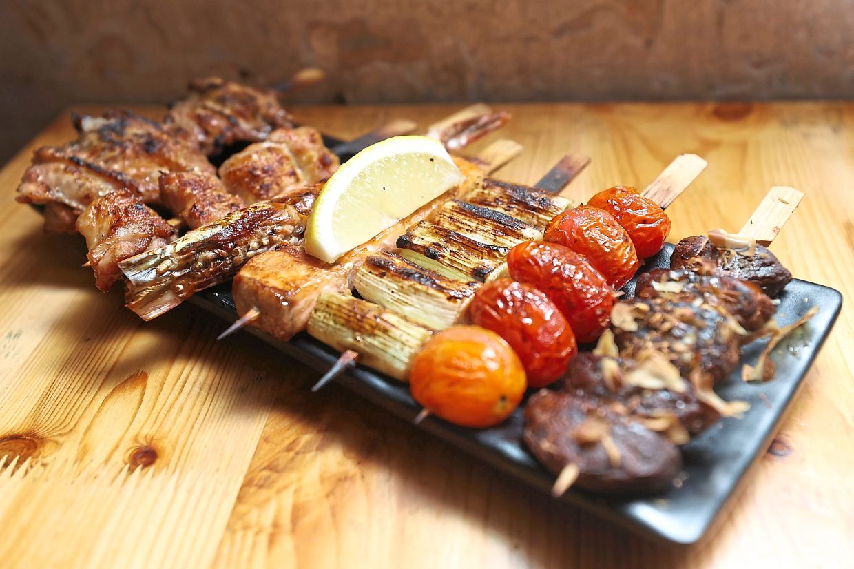The Yakitori Platter comes with chicken thigh and wing, salmon, prawn, leek, cherry tomatoes and shiitake mushrooms.