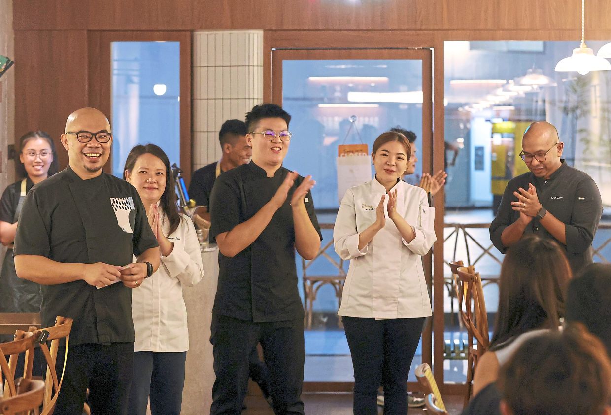 (From left) Tan, Siew, Ng, Lee and Arief taking a round of applause for their culinary mastery in creating the ‘10 Hands, 5-Course Collaboration Menu’. — Photos: CHAN TAK KONG/The Star