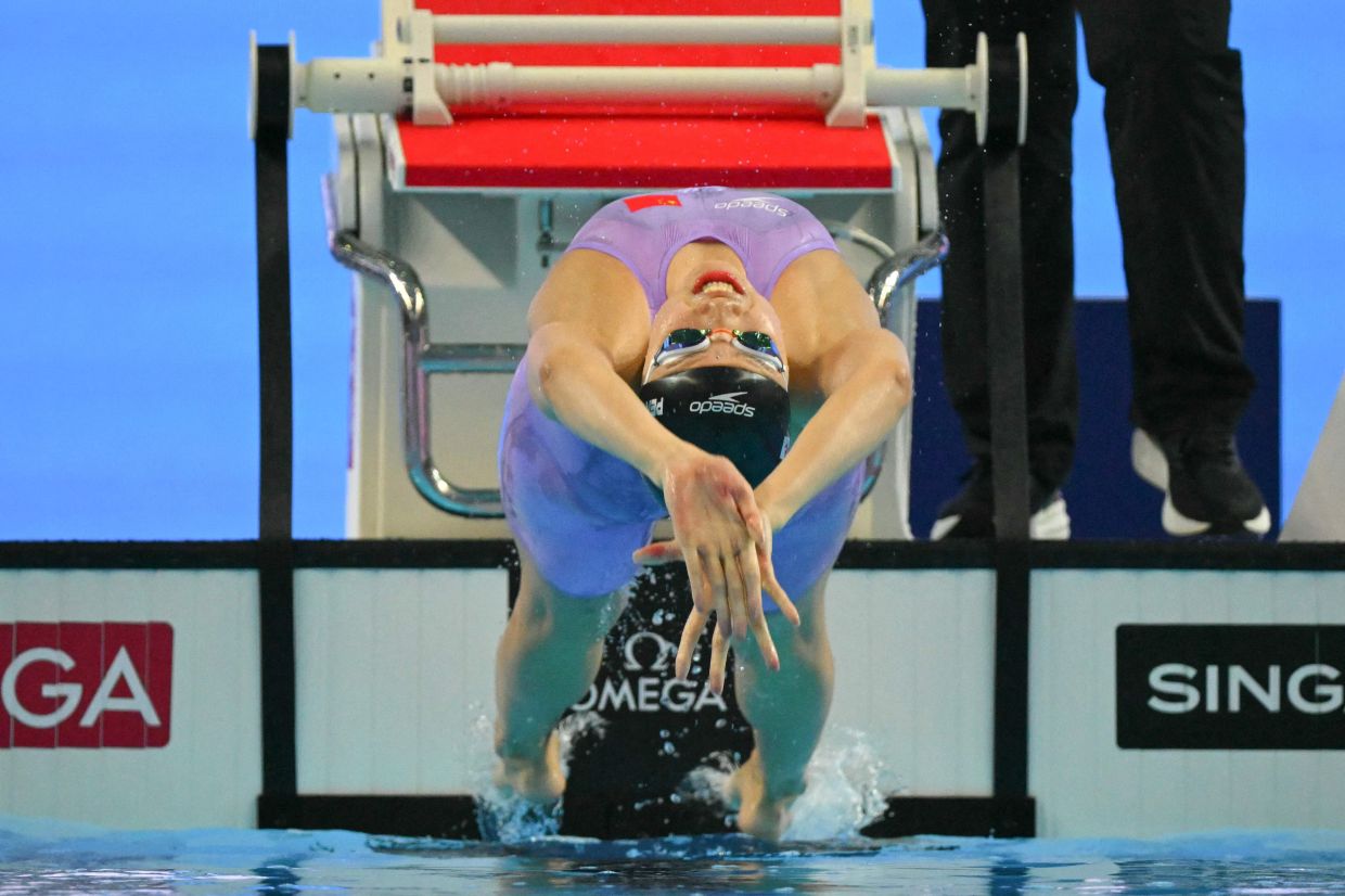 China's swimmer Peng Xuwei dives as she competes in a semi-final of the women's 200m backstroke swimming event during the 2025 World Aquatics Championships in Singapore on Friday, August 1, 2025. -- Photo by François-Xavier MARIT / AFP