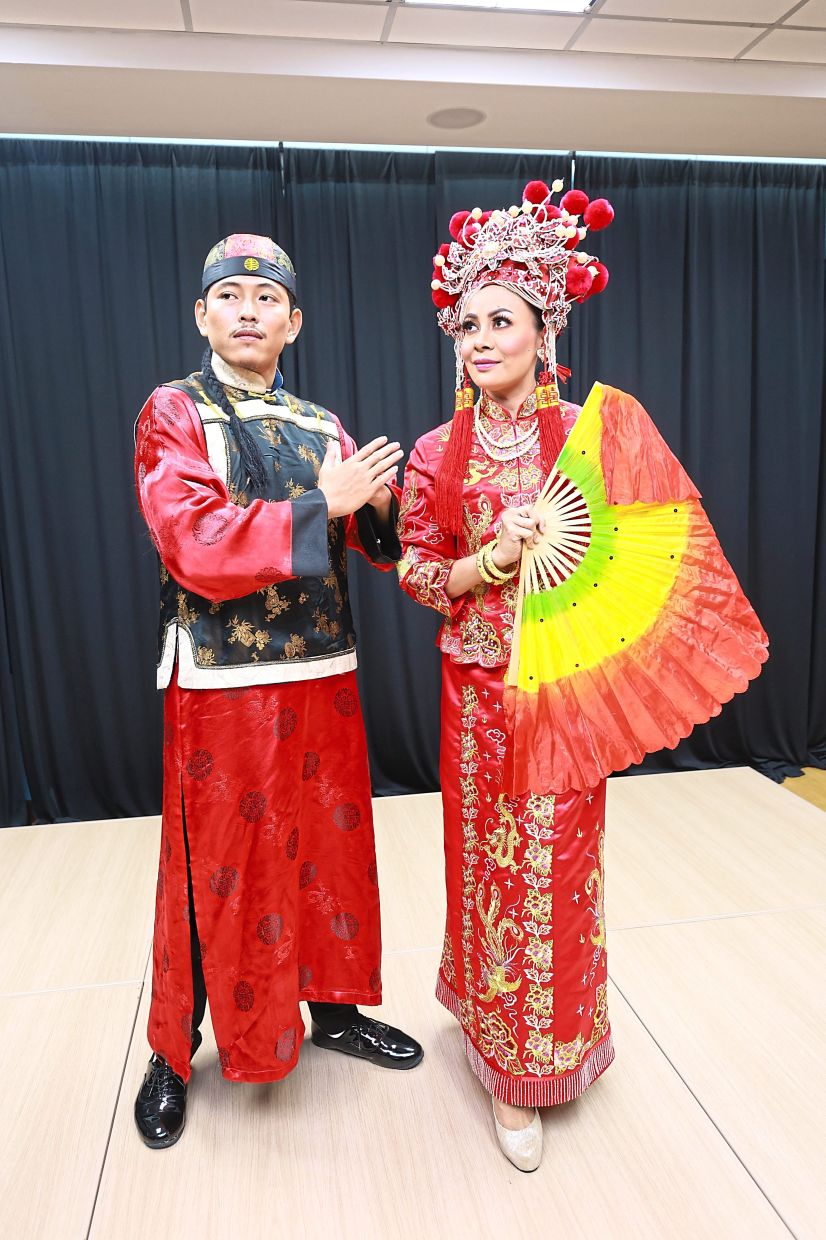 DBKL dancers, Haslinda Abdul Halim, 36, and Adam Khaiqal, 31, from Selangor, all striking a pose in full Chinese costume.