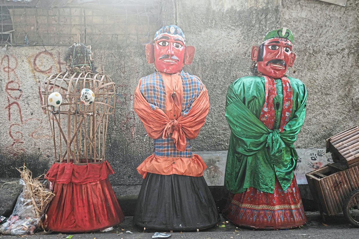 A row of unfinished ondel-ondel puppets, large traditional figures from Jakarta's Betawi culture originally used to ward off evil spirits. Photo: AFP