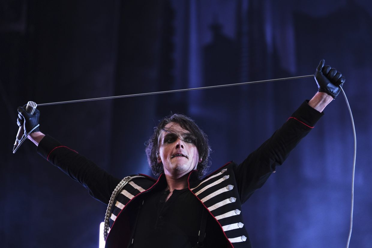 Lead vocalist Gerard Way of My Chemical Romance holds up the microphone while performing during the opening night of the band's 'Long Live the Black Parade' tour. — AP Photo/Lindsey Wasson