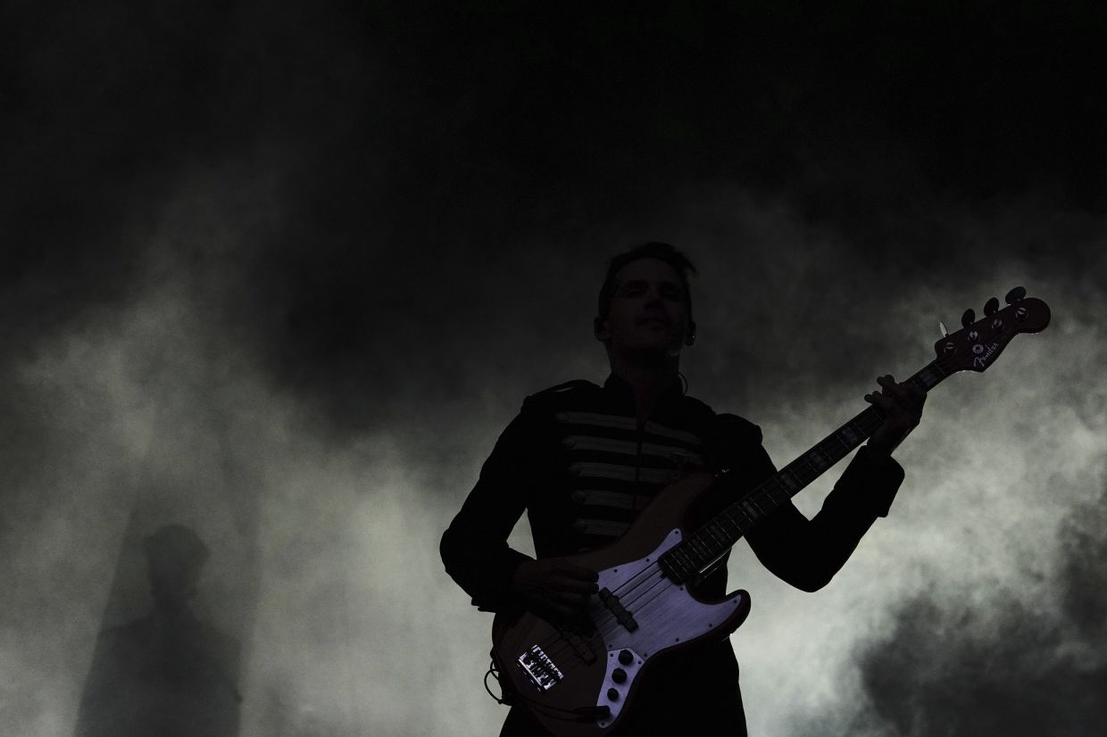 Bassist Mikey Way of My Chemical Romance is silhouetted in stage fog while performing in Seattle. — AP Photo/Lindsey Wasson