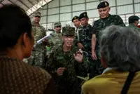 Thailand returns two wounded soldiers to Cambodia but continues to hold 18 of their comrades