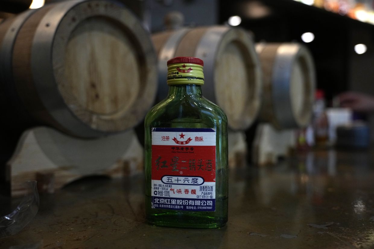 A bottle of a popular brand of the fiery Chinese baijiu spirit is seen at a bar in Beijing, China, Friday, June 13, 2025. (AP Photo/Ng Han Guan)