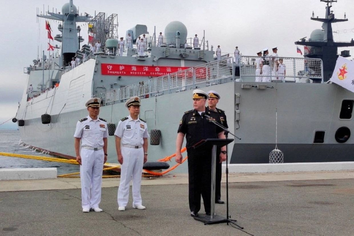 Russian and Chinese naval officers take part in a ceremony Thursday ahead of the start of joint naval drills in the Sea of Japan, following the arrival of Chinese military vessels in Vladivostok, Russia. - Photo: Russian Defense Ministry / Russia's Pacific Fleet / via Reuters
