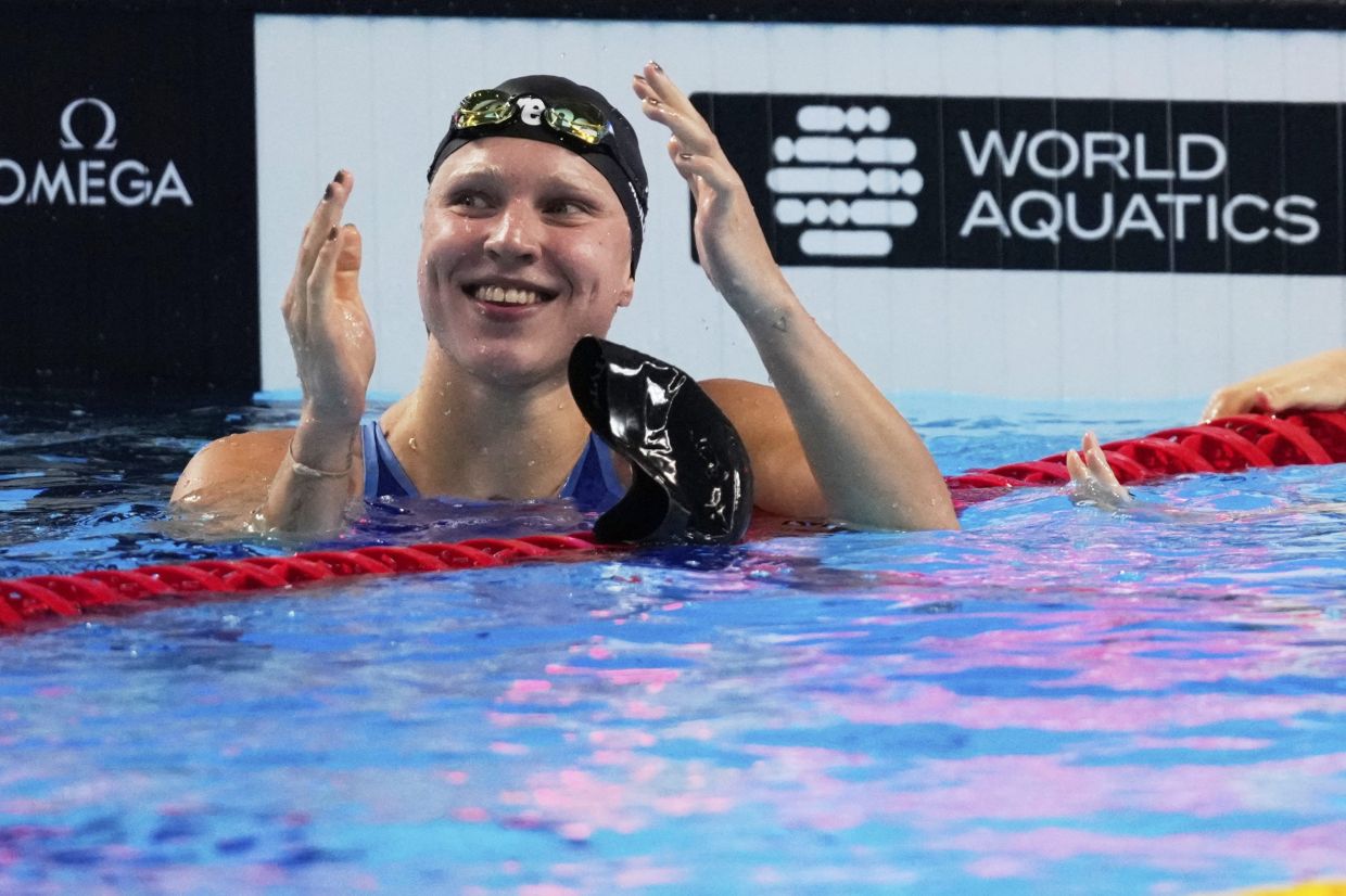 Ruta Meilutyte of Lithuania reacts after winning the gold medal in the women's 50-meter breaststroke final at the World Aquatics Championships in Singapore, Sunday, Aug. 3, 2025. -- AP Photo/Vincent Thian