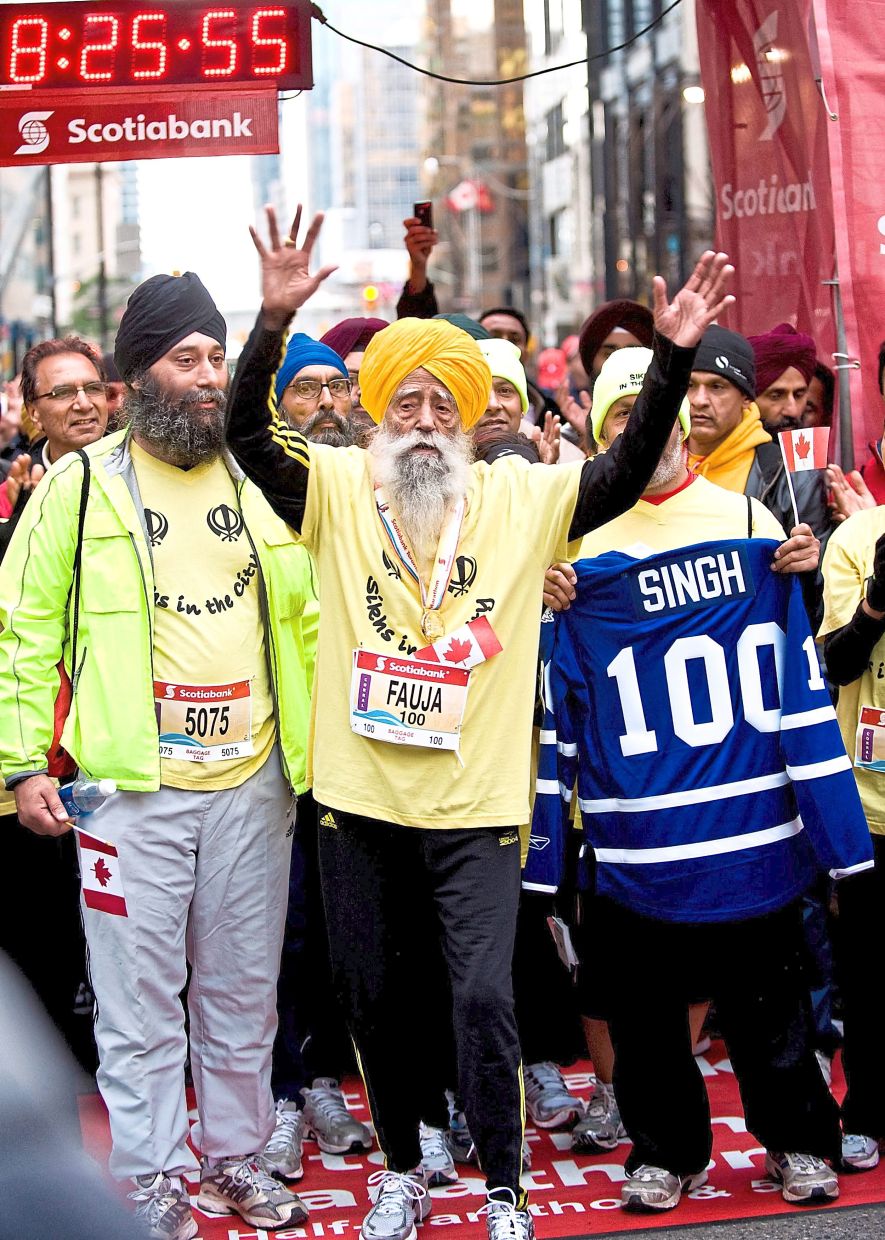 Fauja jubilates as he completes the 2011 Scotiabank Toronto Waterfront Marathon on Oct 16, 2011, at the age of 100. — AFP