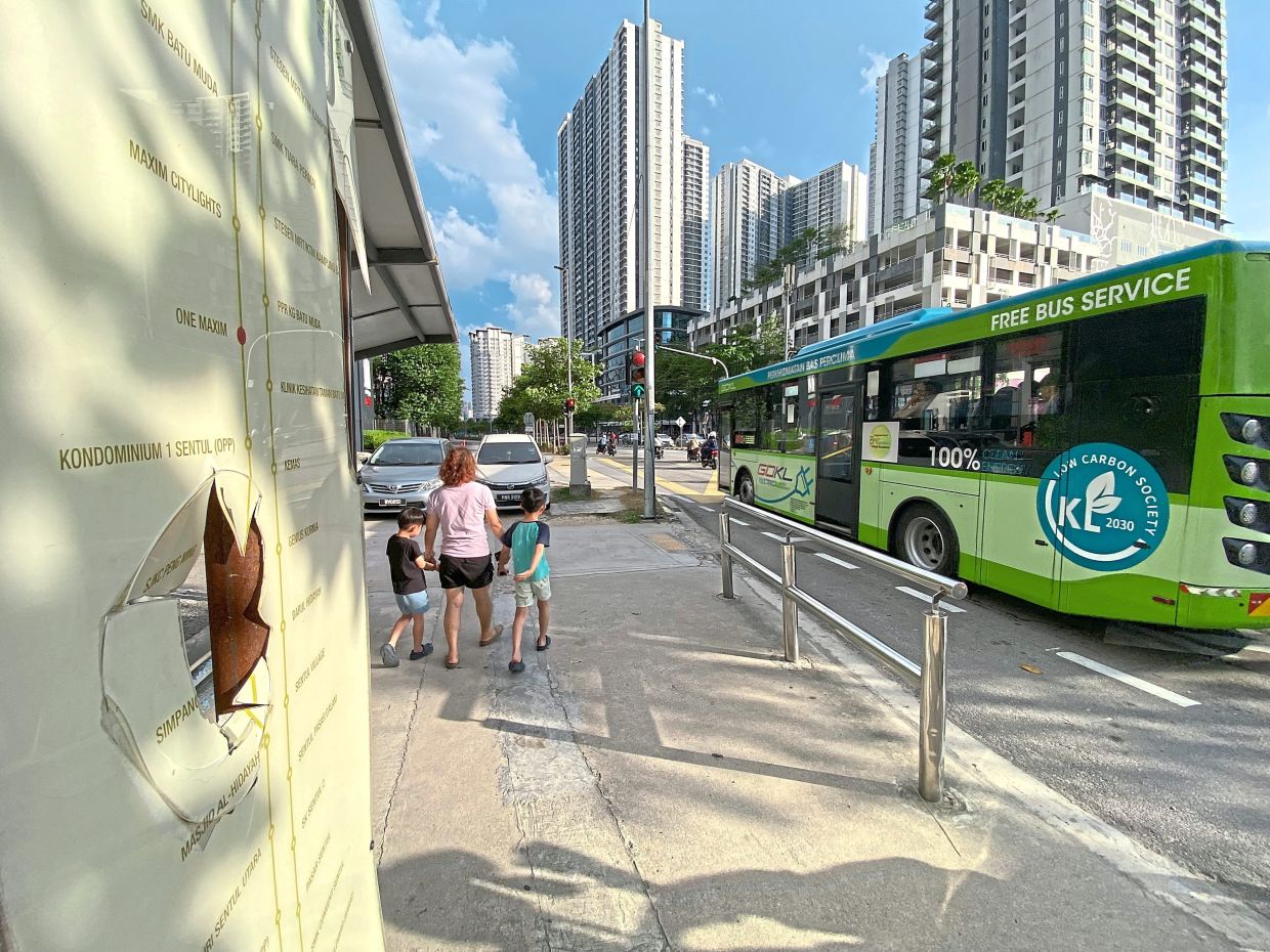 The vandalised GoKL route display board (left) at the bus stop outside M Centura Condominium. — GLENN GUAN, ONG SOON HIN, JAROD LIM andLEW GUAN XI/The Star