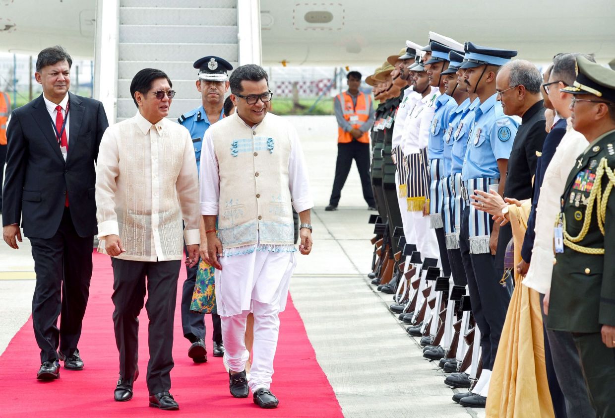 Philippines' President Ferdinand Marcos (second left) walks alongside India's Minister of State for External Affairs Pabitra Margherita (centre) as he inspects the honour guards upon his arrival at the airport in New Delhi. Marcos arrived in India on Monday, August 4, on a visit aimed at strengthening defence and strategic ties between nations as they navigate tensions with China across the Asia-Pacific. - Photo by Indian Press Information Bureau (PIB) / AFP