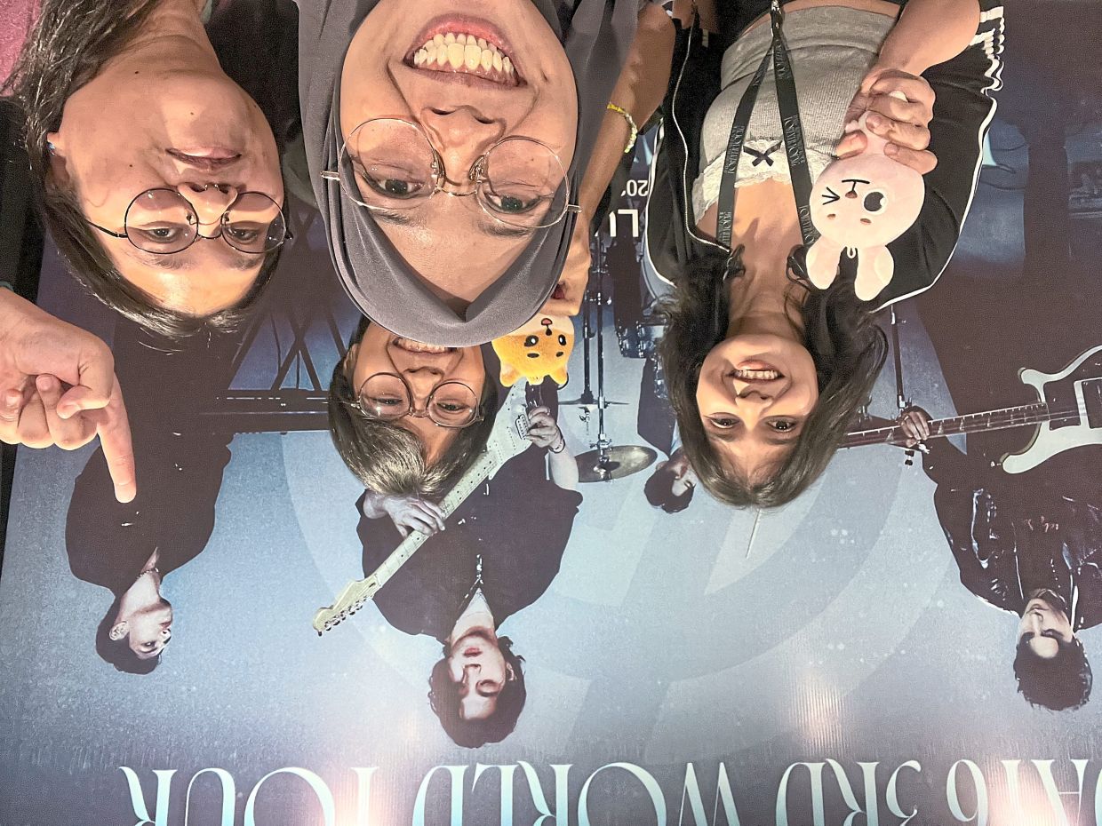 Going to concerts is one way Nguyen (back, holding a plushie) makes new friends. — LINH NGUYEN