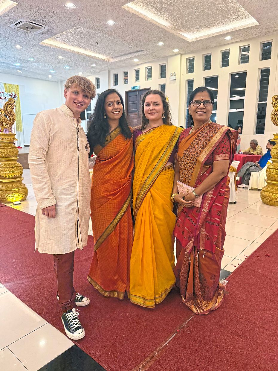 Kavinah (second from left) attending a wedding in Malaysia with her mother (right) and her Polish friends. — KAVINAH MANIAM