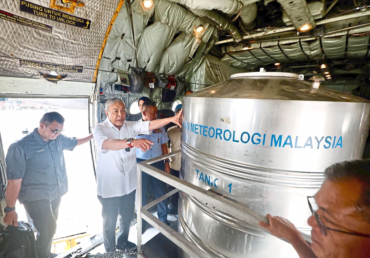 Drought fighter: Ahmad Zahid aboard the C-130 Hercules before taking off from the TUDM Subang Air Base for cloud seeding operations. — FAIHAN GHANI/The Star