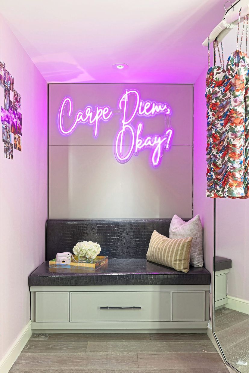 The room has a neon sign that reads, 'Carpe Diem, okay?', which is one of the many memorable quotes from the movie.