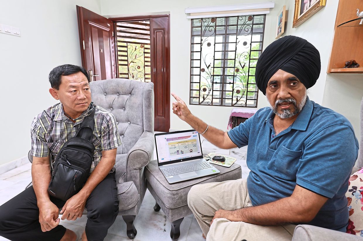 Lee (left) and Sukhdev are against redeveloping Pangsapuri Cantik. They say the four-storey apartment building only needs refurbishment.