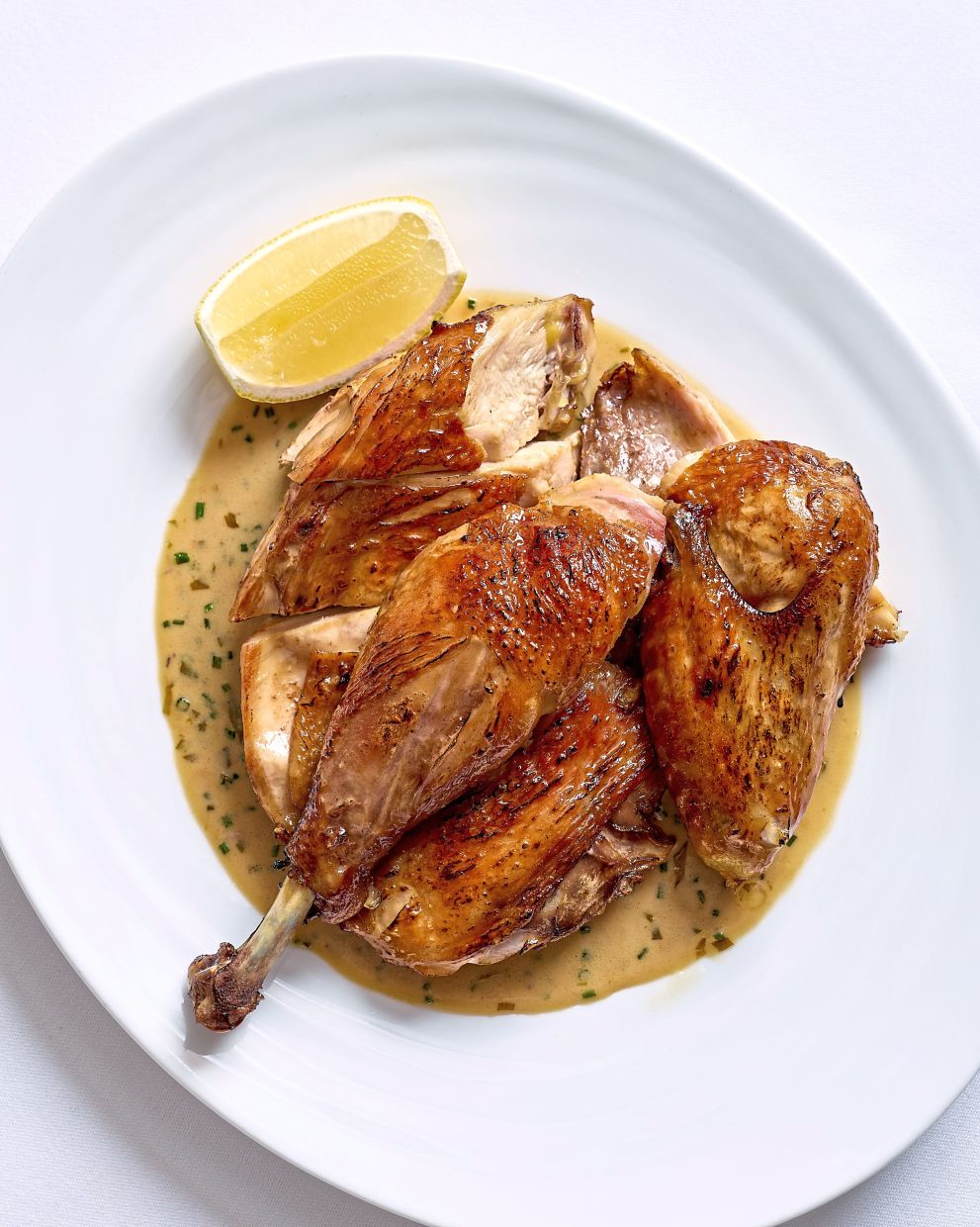 David's roast chicken boasts a lovely golden brown skin that then segues into juicy flesh within. — Cafe Bistrot David
