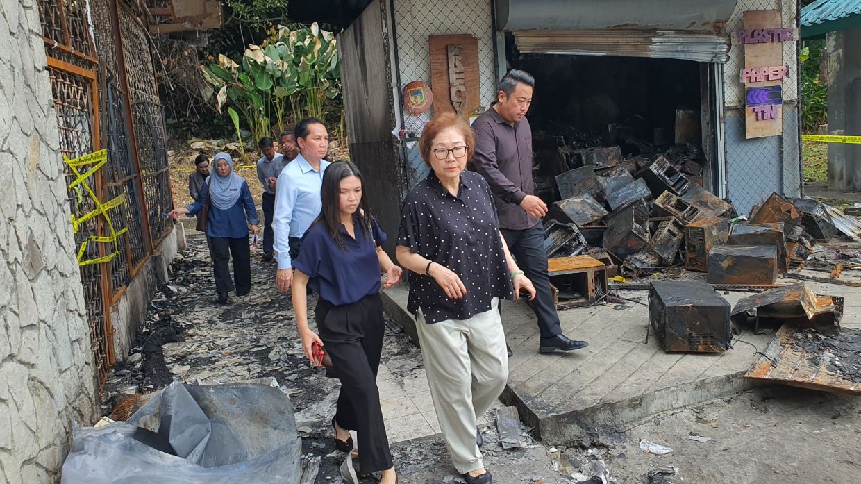 State Tourism, Environment Minister Datuk Christina Liew (centre) checking out the gutted Kota Kinabalu Community Centre during a site visit.