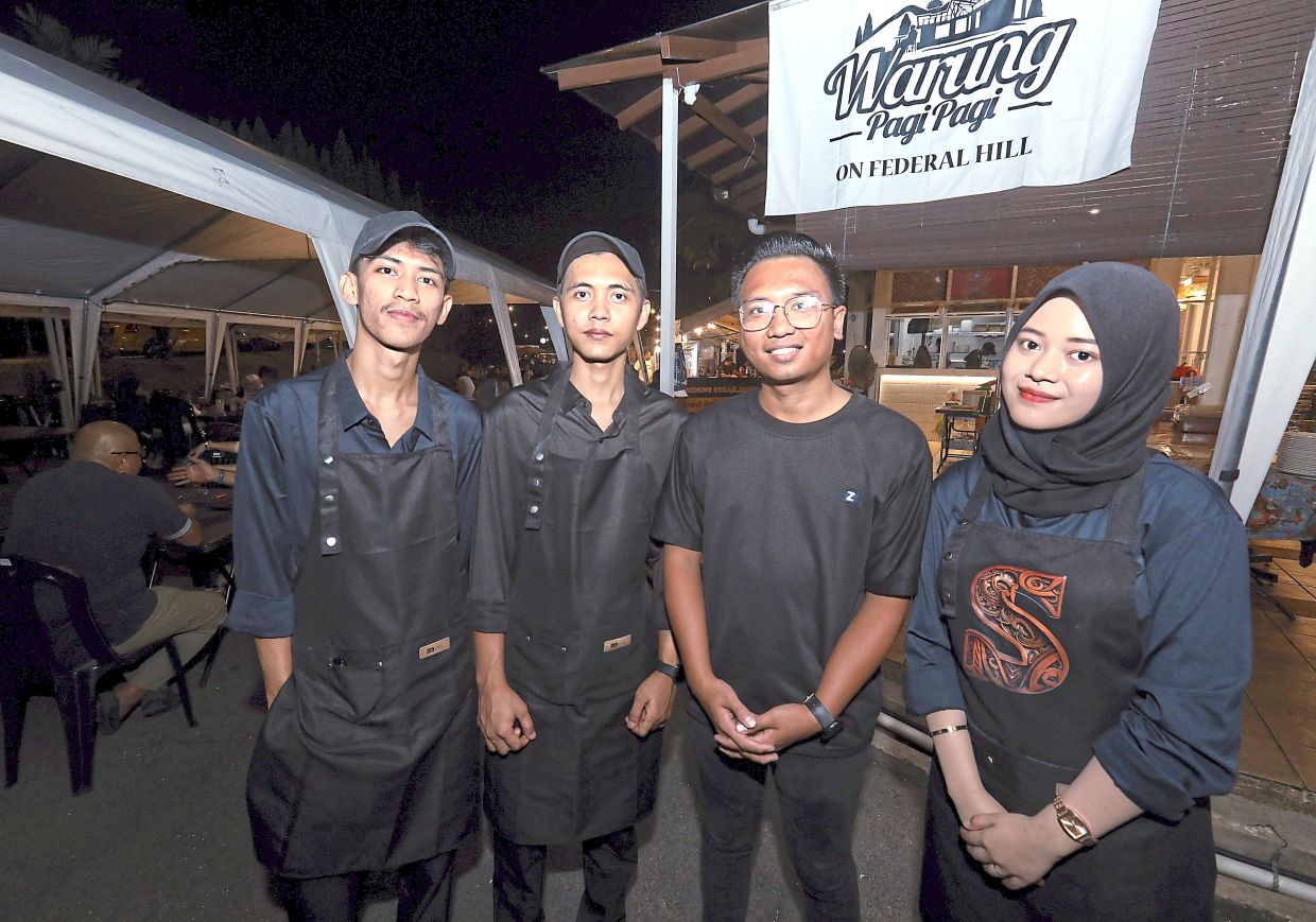 Asni (second from right) along with other Warung PagiPagi employees.