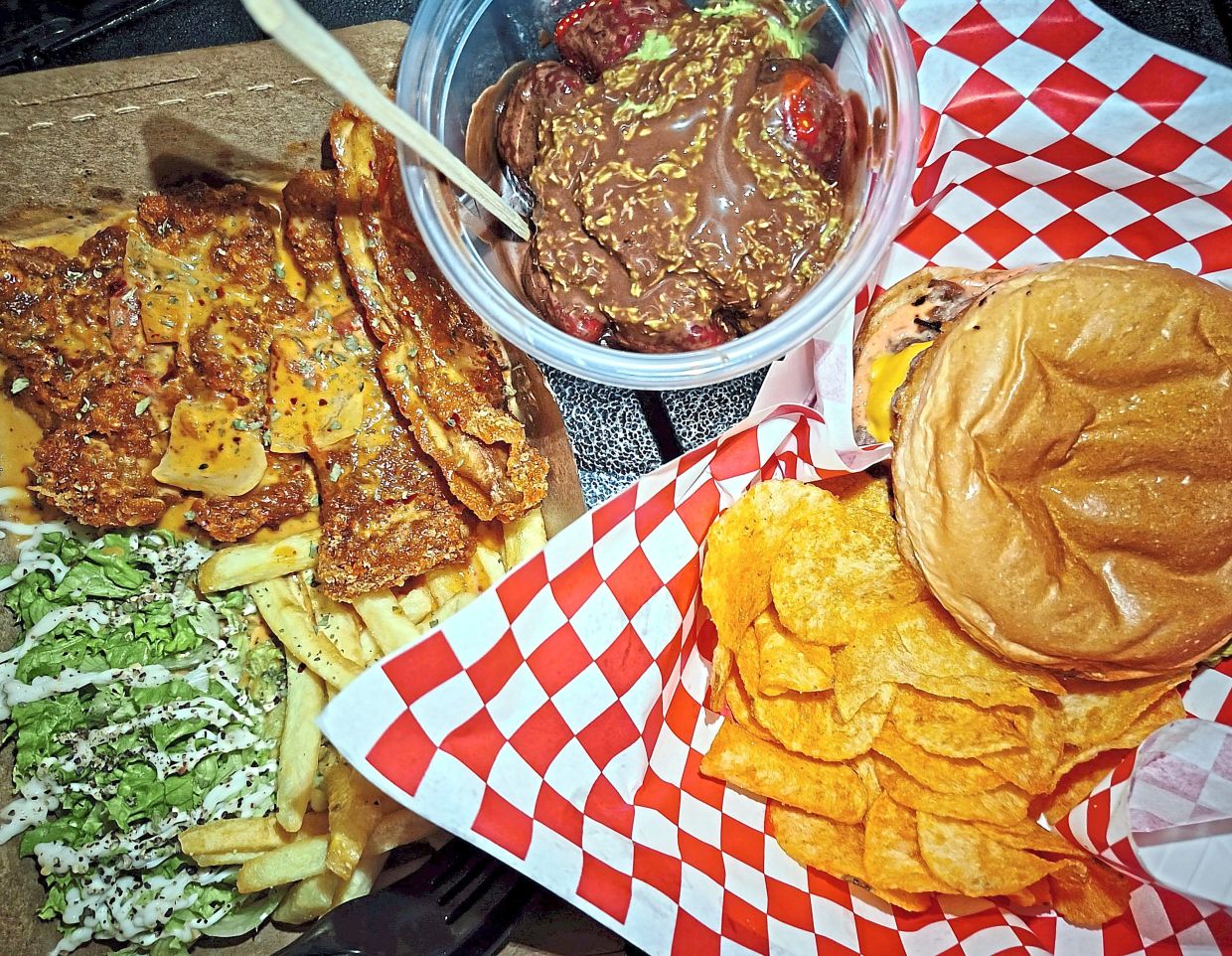 (From left) Fried Chicken Chop; chocolate-coated strawberries with pistachio kunafa sauce; smashed burger.
