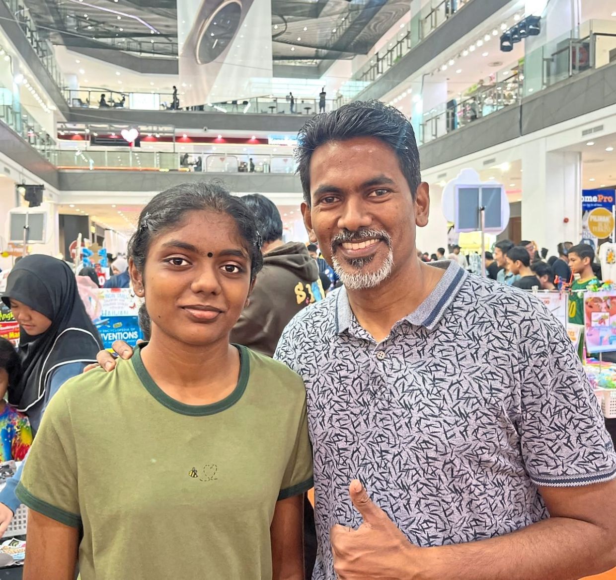 Jegathesan, with daughter J. Thanushree, says international book bazaars can serve as a form of cultural exchange.