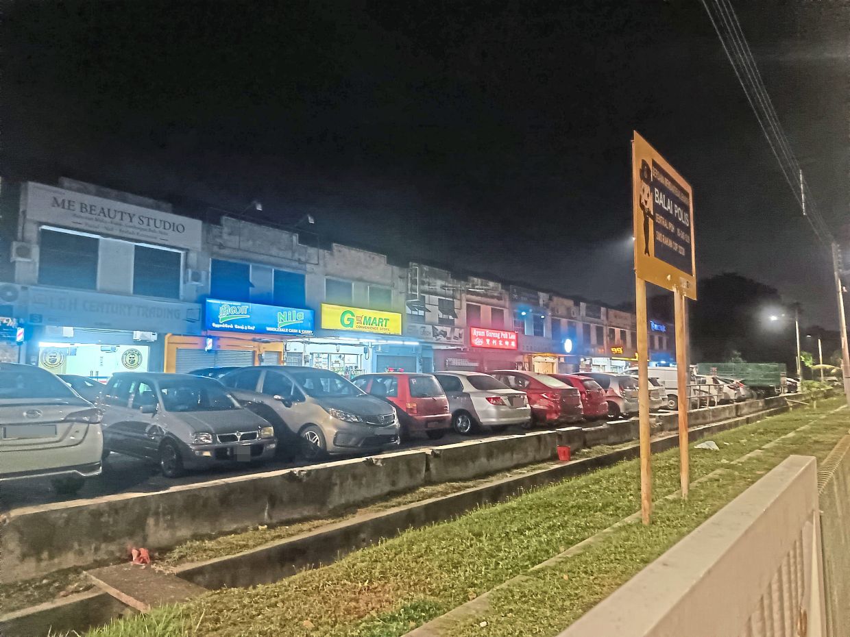 Cars parked in front of shops before the start of night market operations.