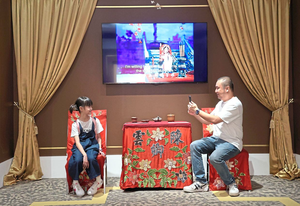 Visitors can discover Chinese opera in Malaysia through video exhibits and interactive displays. Photo: The Star/Art Chen