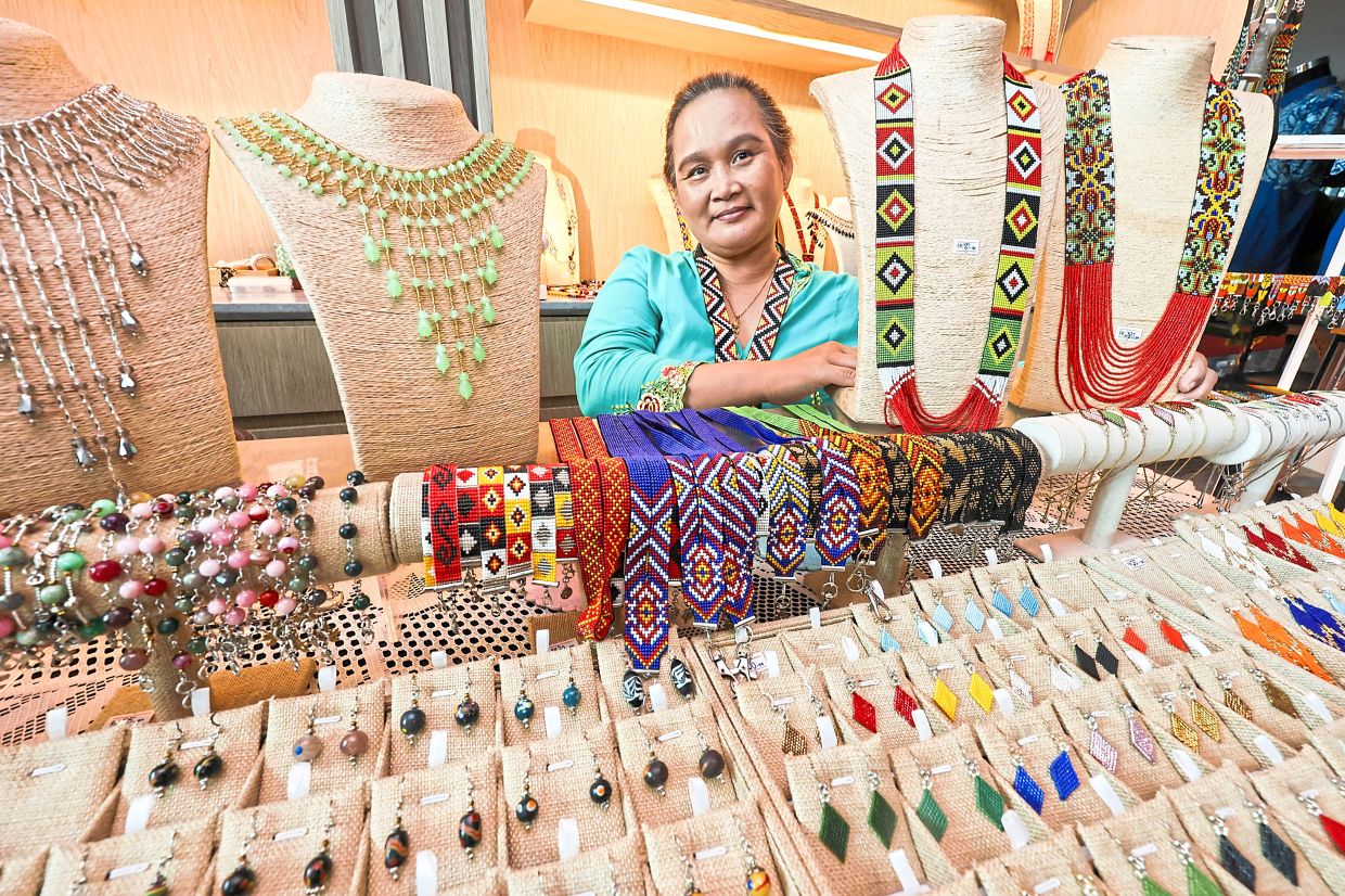 Attractive colours: Ezra showing her range of bead accessories which includes traditional Bidayuh necklaces and contemporary creations.