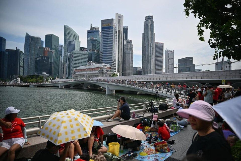 People gathering outside the Esplanade ahead of the National Day Parade on Aug 9. - Photo: ST