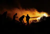 Two Vietnamese tourists confirmed dead as firefighters battle blaze near Athens for second day