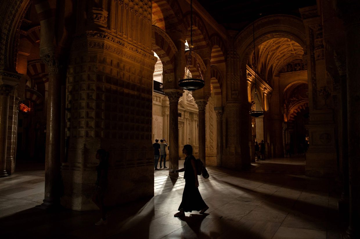 Tourists visit the historic mosque-cathedral of Cordoba after a fire broke out the previous day in the monument in Cordoba southern Spain on Aug 9. Photo: AFP