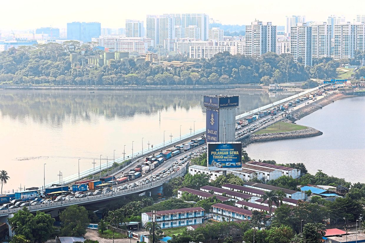 On an average day, around 450,000 people cross the Malaysia-Singapore border over the two physical links. — THOMAS YONG/The Star